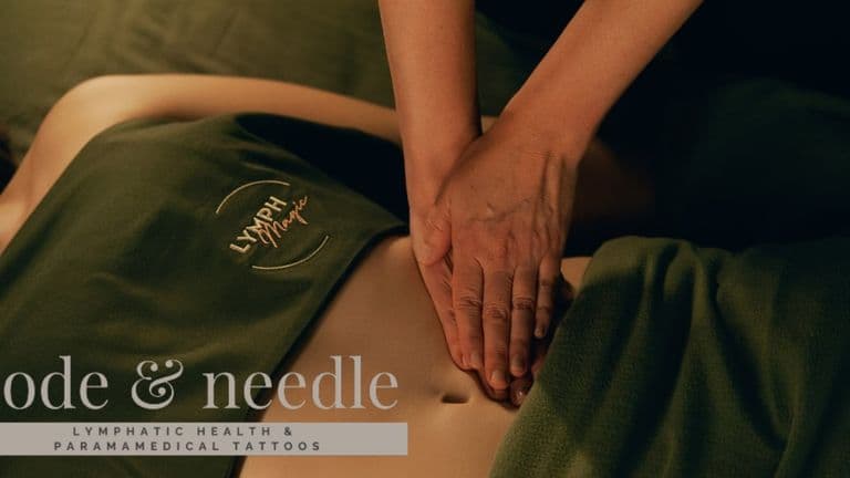 Therapeutic lymphatic massage session with hands gently pressing on a client's abdomen, promoting healing and recovery.