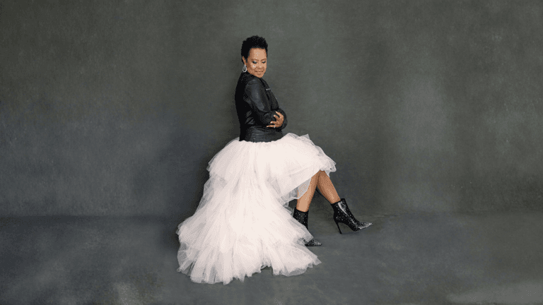 "Mag Dalé, a lawyer-turned-singer-songwriter, posing confidently in a leather jacket and tulle skirt, embodying resilience and style."