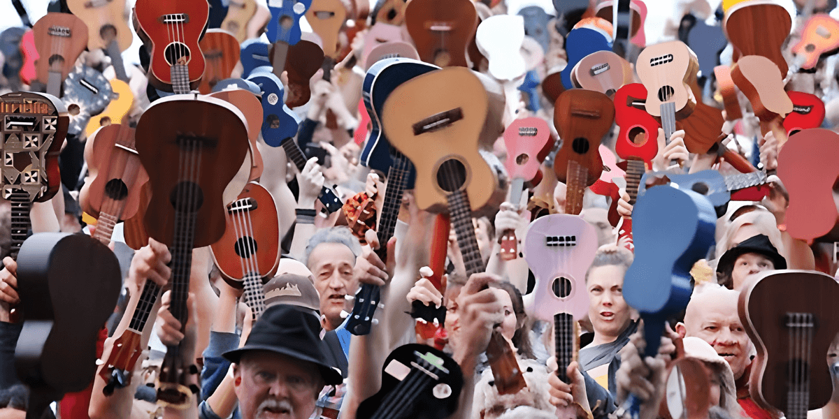 Crowd of people holding various ukuleles in celebration and unity