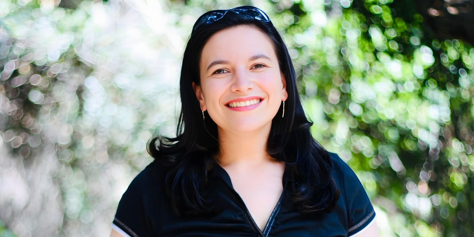 Dr. Jen Ferris smiling outdoors, promoting self-compassion in parenting to foster resilience in children and family connections.