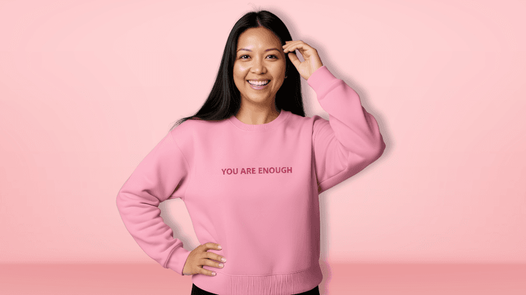 "Ara Jaingue, founder of Mama Tribe United, speaking at an event, promoting healing through science-backed affirmation apparel for mothers."