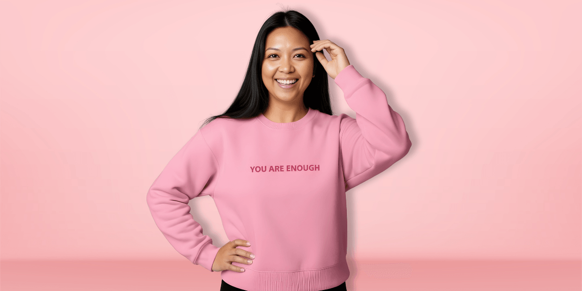 "Ara Jaingue, founder of Mama Tribe United, speaking at an event, promoting healing through science-backed affirmation apparel for mothers."