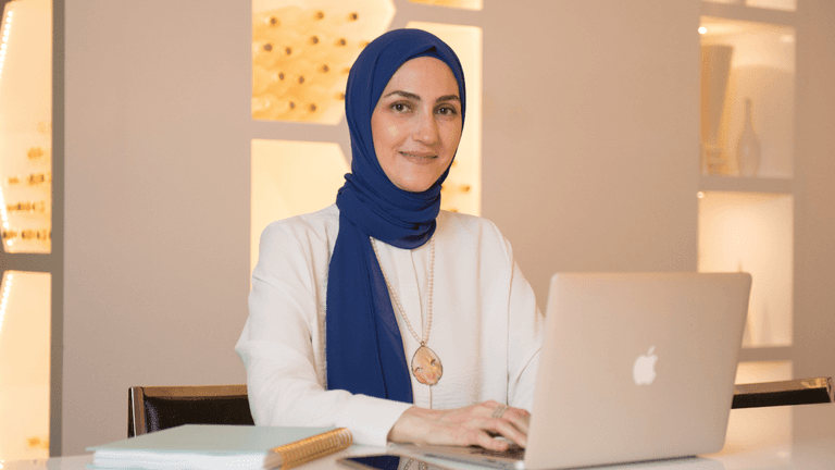 Rania Jaghlit, founder of Magna Empowerment, in a professional setting, empowering women to embrace authenticity and live purposefully.