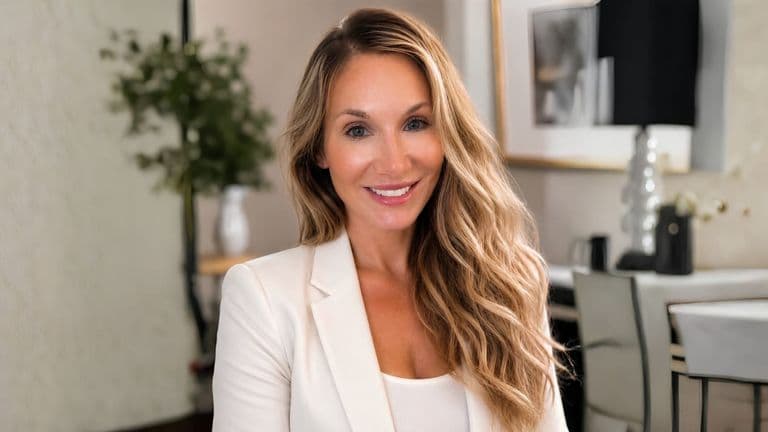 Katie Zoulek wearing a white blazer in a contemporary interior.