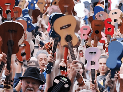 Crowd of people holding various ukuleles in celebration and unity