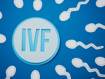 Illustration of sperm around a circular IVF emblem on a blue background