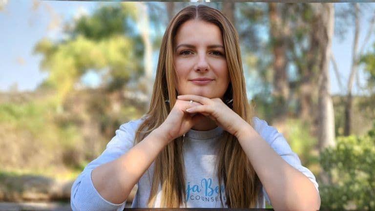 Vanja Beric, a counselor, sitting outdoors with a calm expression, symbolizing emotional connection and trust in relationships.