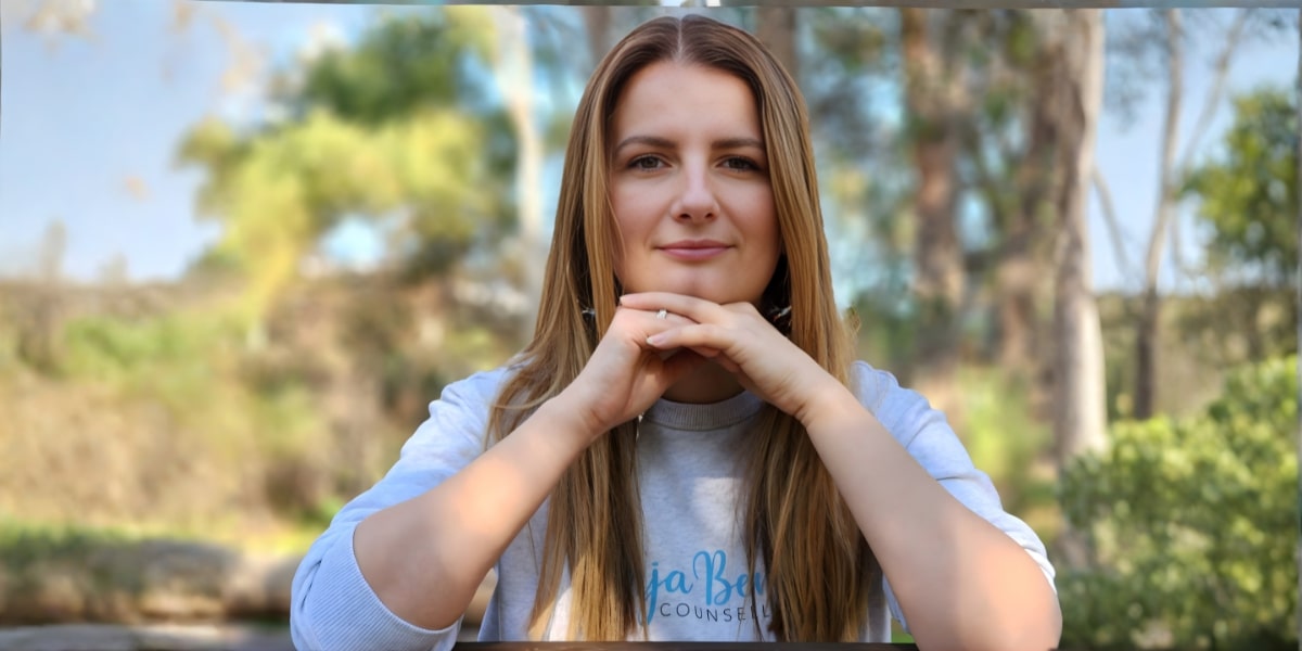 Vanja Beric, a counselor, sitting outdoors with a calm expression, symbolizing emotional connection and trust in relationships.