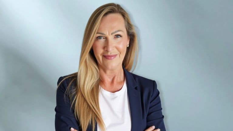 Jess Smith, anxiety and phobia coach, smiling confidently in a blazer, offering healing through compassionate coaching and writing.