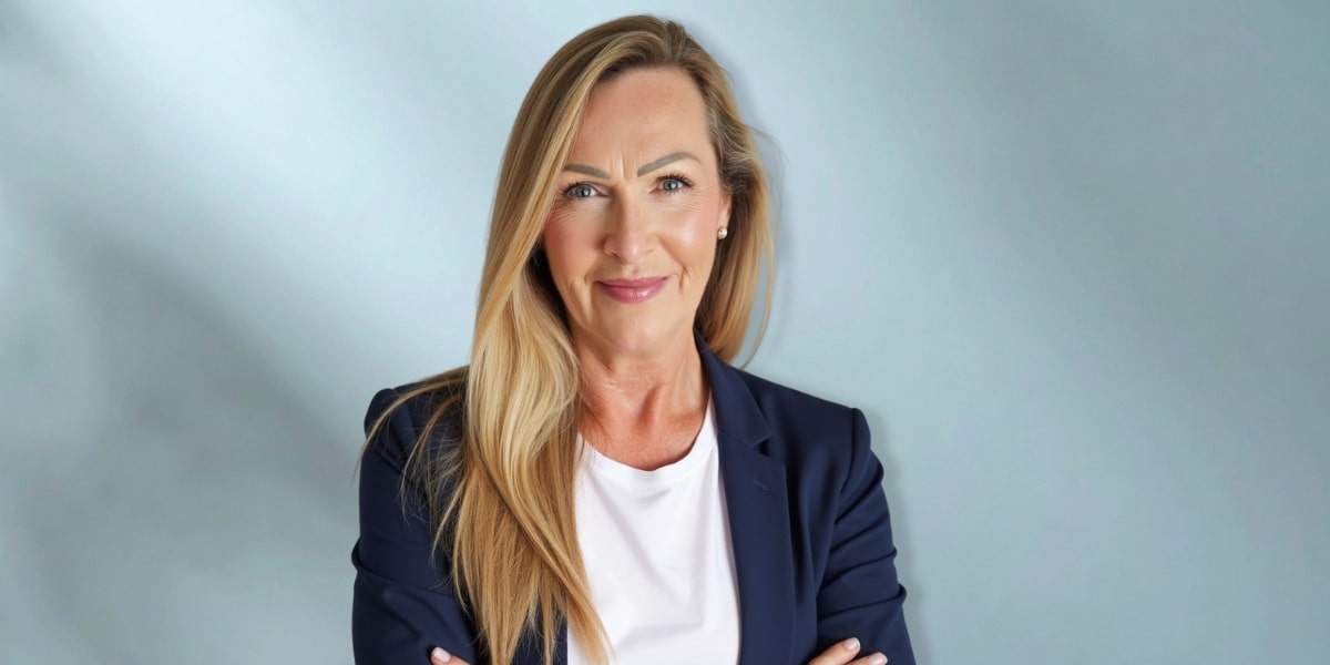 Jess Smith, anxiety and phobia coach, smiling confidently in a blazer, offering healing through compassionate coaching and writing.