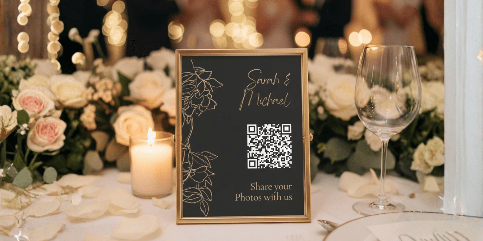 Framed sign with QR code for guests to share photos at a wedding event, featuring floral decorations and candles.