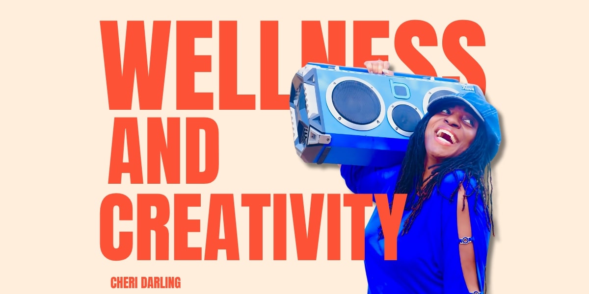 Image of Cheri Darling smiling while holding a blue boombox, symbolizing wellness, creativity, and self-care empowerment.