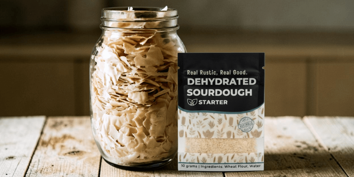 Jar of dehydrated sourdough starter flakes beside a packaged Real Rustic Sourdough starter.