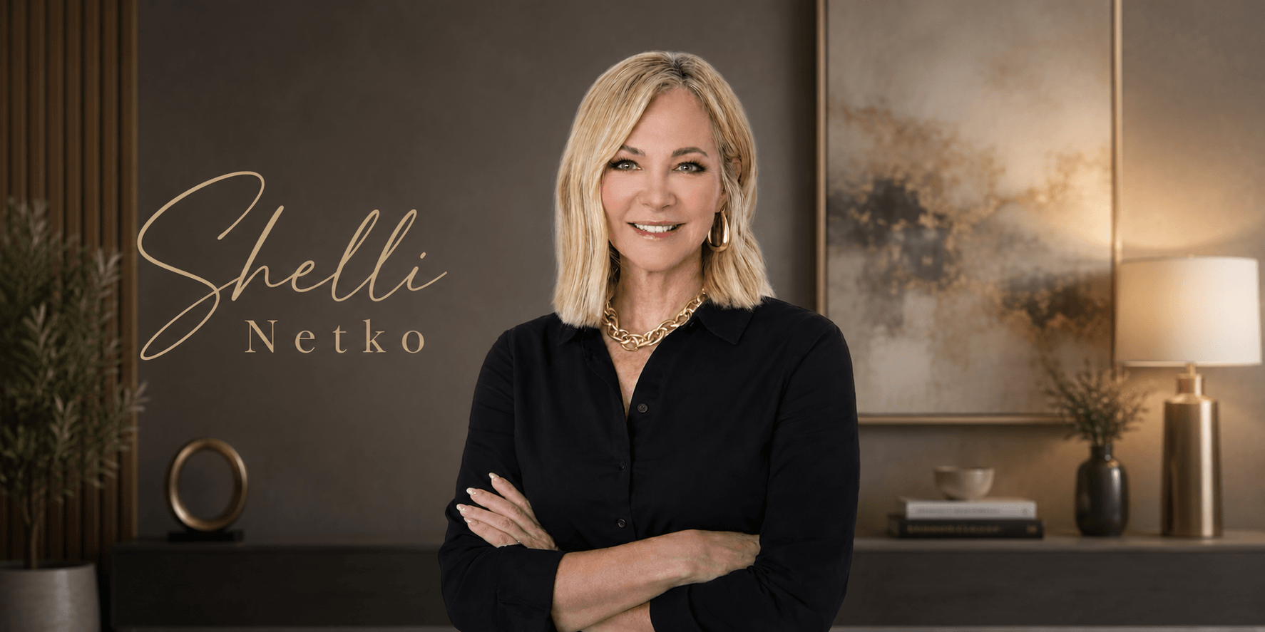 Professional portrait of blonde woman in black blouse, arms crossed, with elegant office backdrop and name logo.