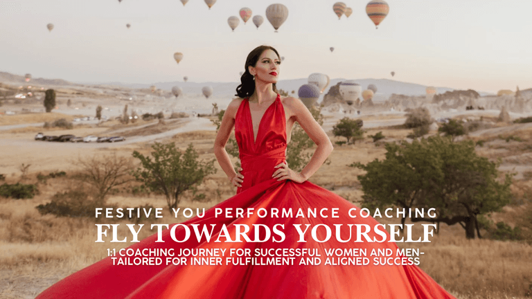 Woman in flowing red dress stands confidently with hot air balloons in the background at sunrise.