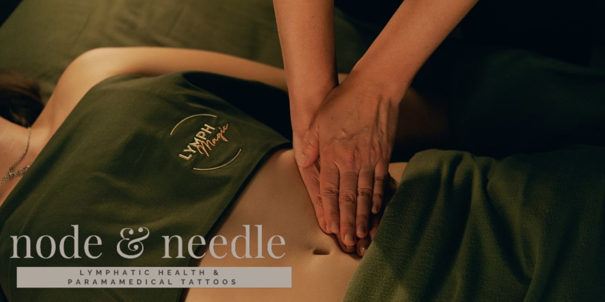Therapeutic lymphatic massage session with hands gently pressing on a client's abdomen, promoting healing and recovery.