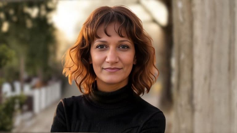 Dr. Jasmin Tzortzakakis Malik, a health educator with a focus on preventive care and empowerment, standing outdoors.