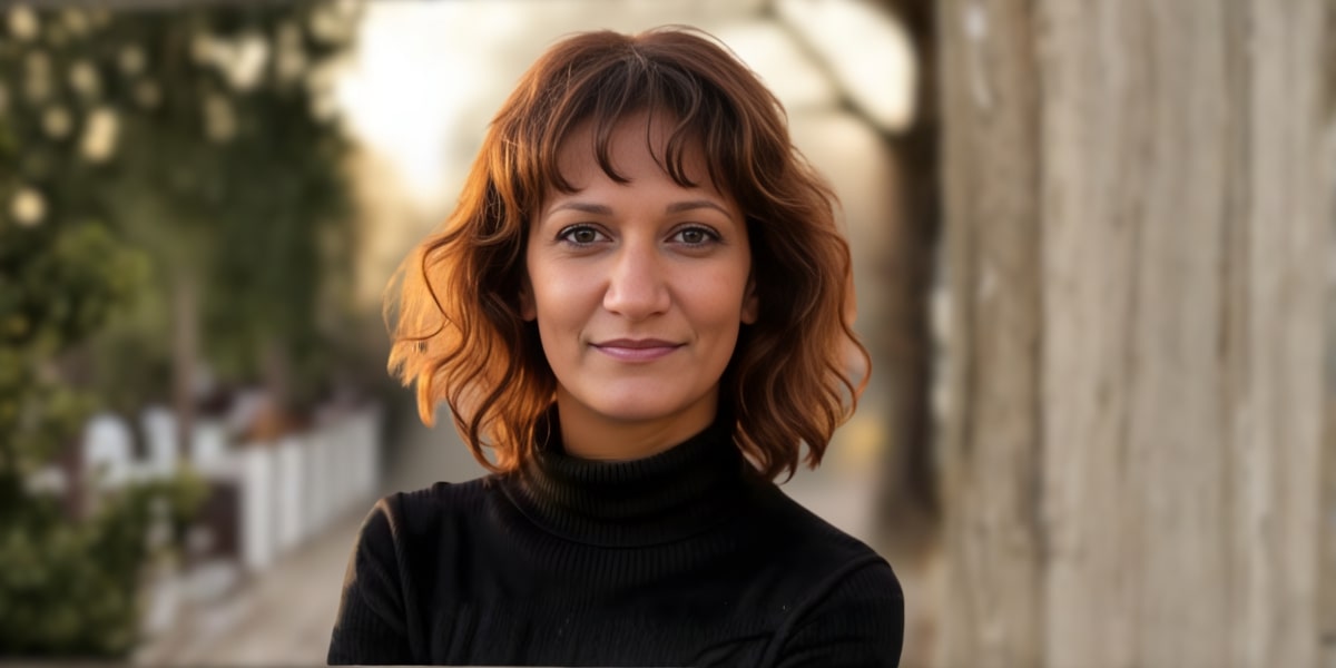 Dr. Jasmin Tzortzakakis Malik, a health educator with a focus on preventive care and empowerment, standing outdoors.