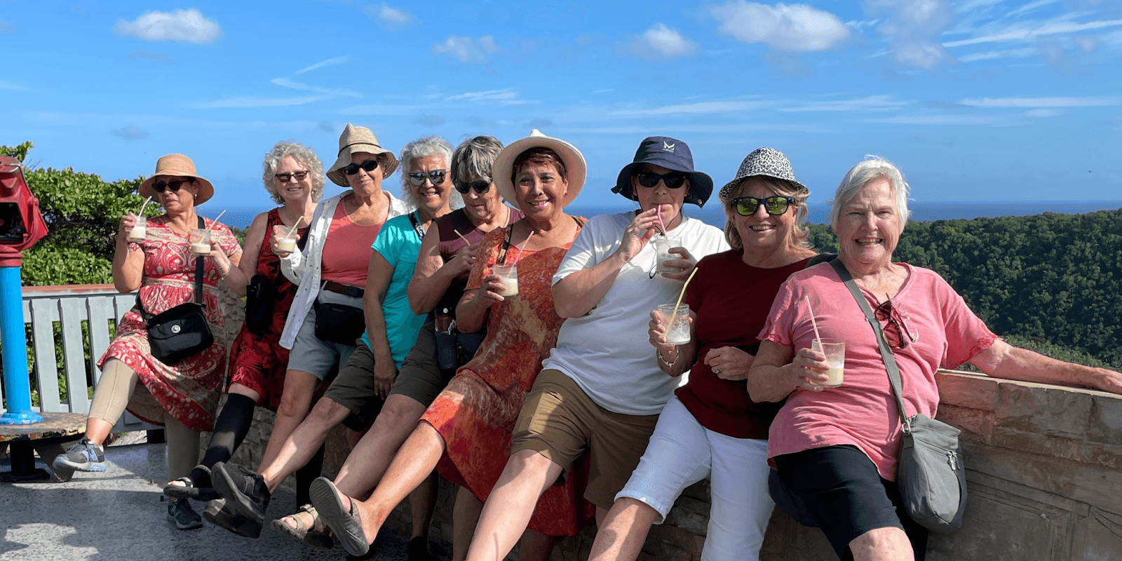 "A group of women over 50 enjoying an adventurous outdoor tour with drinks, smiling and bonding in a scenic setting."