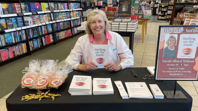 Dr. Sarah Wilson, author and dentist, smiling in a professional setting, showcasing her memoir "Smiling on the Inside".