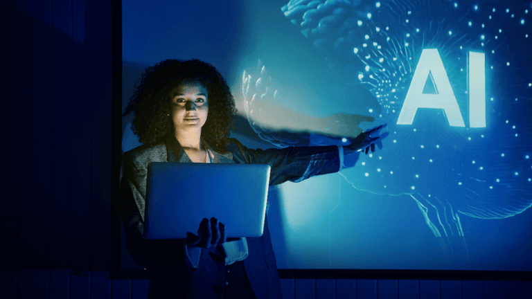 Professional holding a laptop while presenting AI concepts on a digital display.