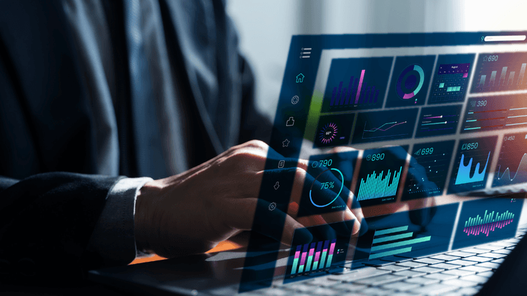 Business professional using a laptop with a digital analytics dashboard and AI data visualizations.