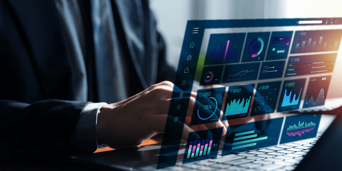 Business professional using a laptop with a digital analytics dashboard and AI data visualizations.