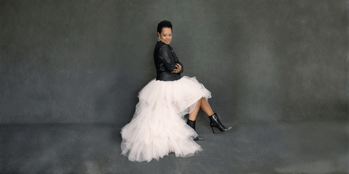 "Mag Dalé, a lawyer-turned-singer-songwriter, posing confidently in a leather jacket and tulle skirt, embodying resilience and style."