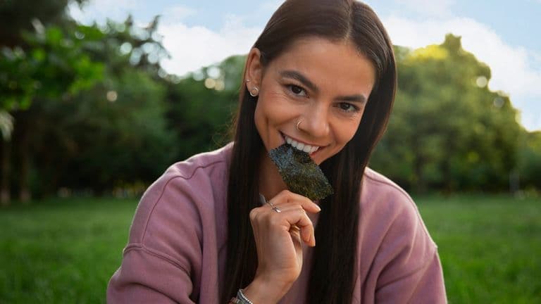 Person Eating Seaweed Snacks 52683 131004