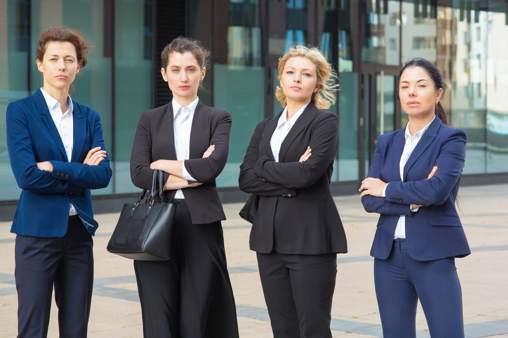 Serious Businesswomen Group With Arms Folded Standing Together Near Office Building Posing Looking Camera Front View Business Team Teamwork Concept 74855 7786
