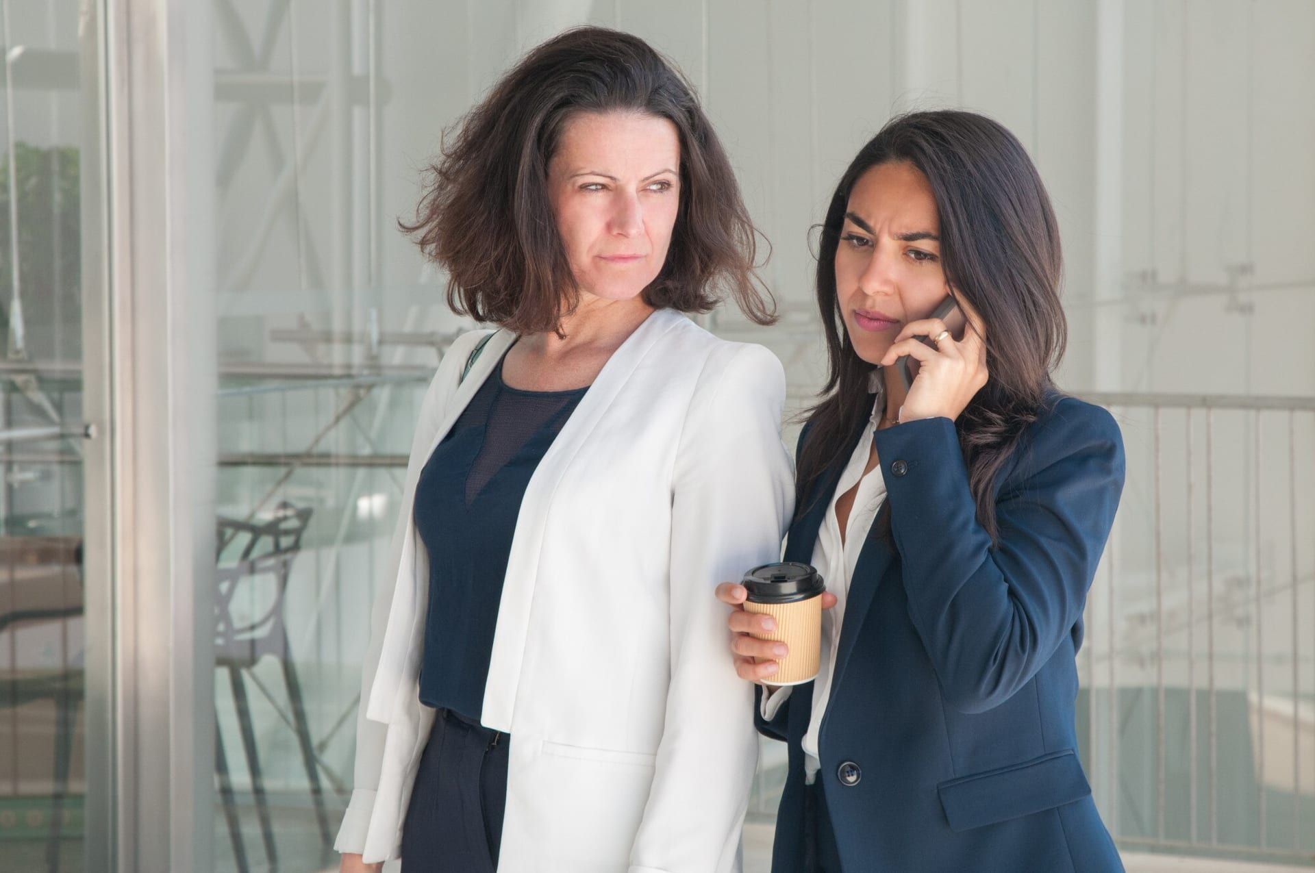 Two Serious Business Women Calling Phone Drinking Coffee 1262 19428