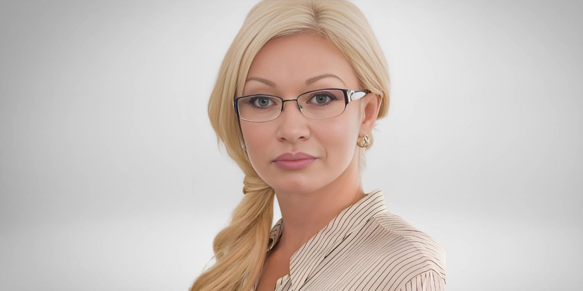 Anastaszia Cash, owner of Desert Divas and Dons Medical Spa, in a professional portrait with glasses.
