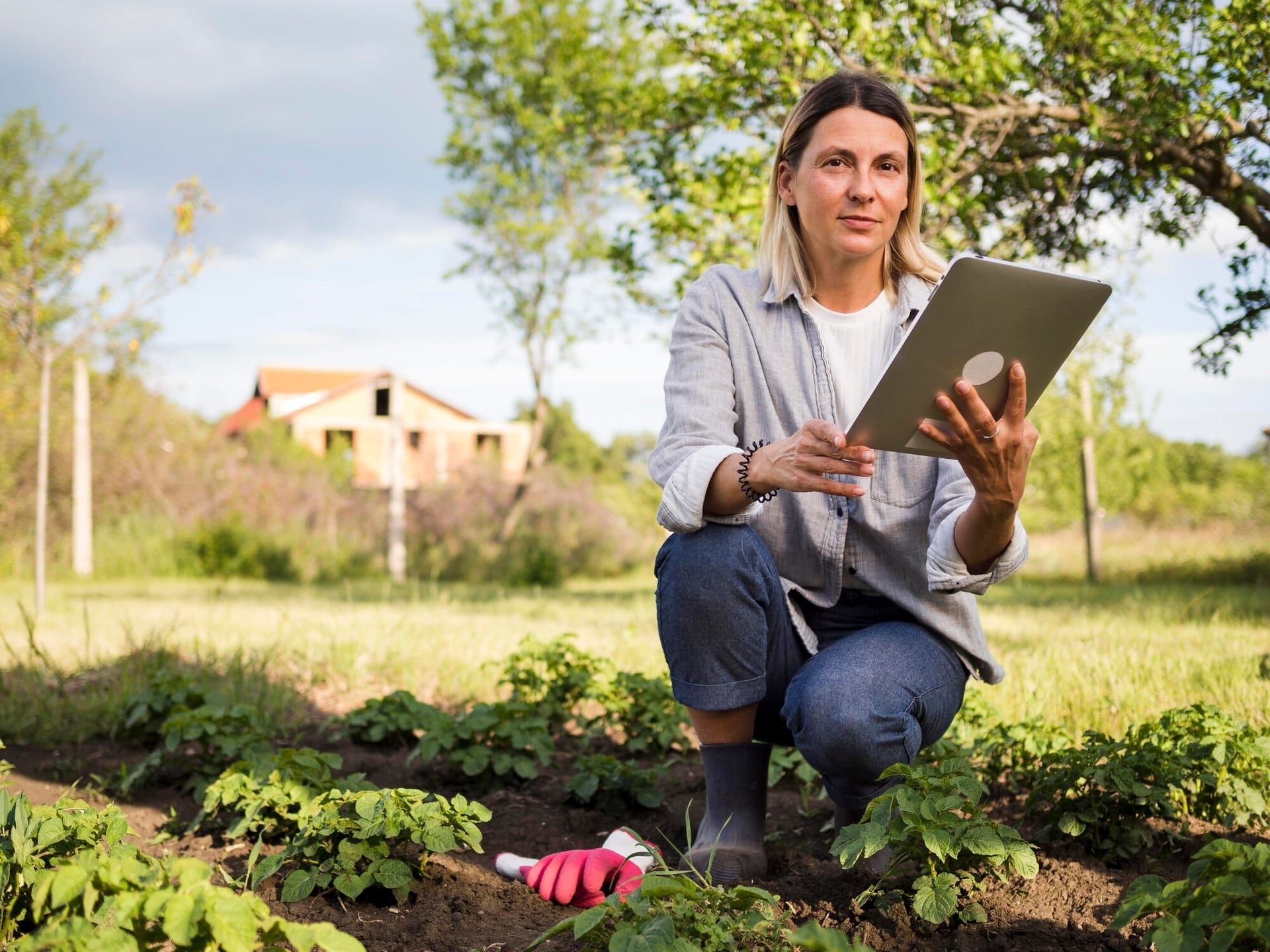 Woman Farmer Checking Her Garden With Tablet 23 2148580082