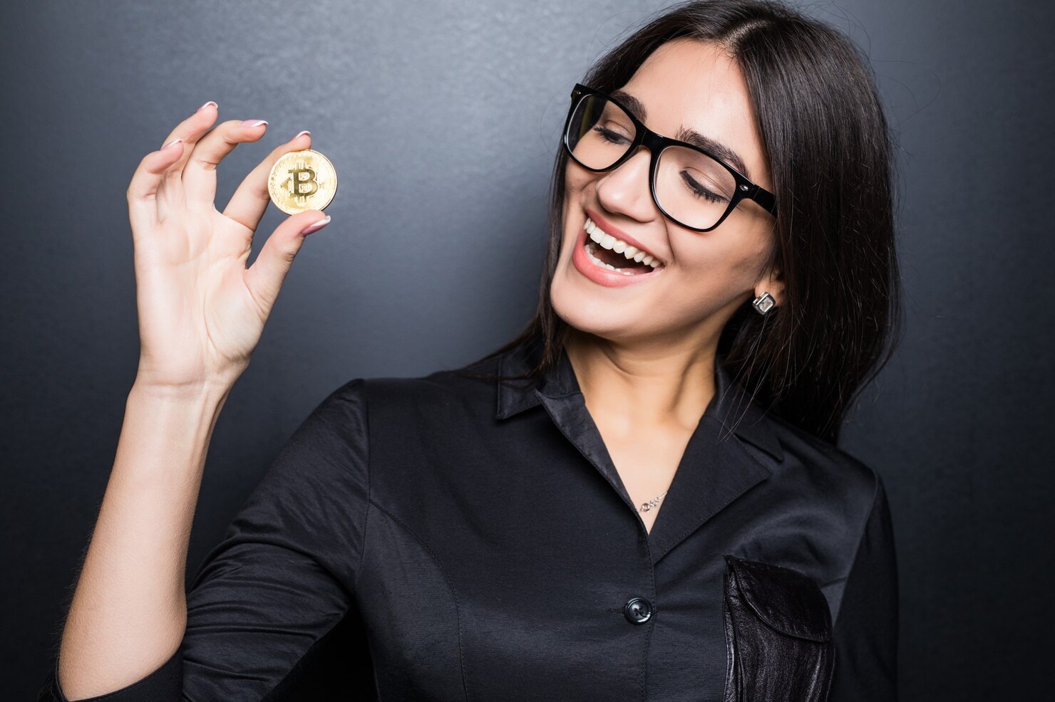 Young Successful Confident Woman With Glasses Holds Gold Bitcoin Her Hand Isolated Black Wall 231208 11713