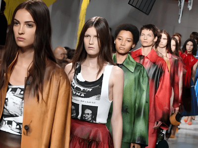 Models walking down a runway in colorful fashion during a clothing showcase